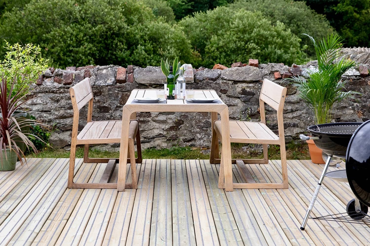 Outdoor dining on non-slip timber deck in Cornish garden