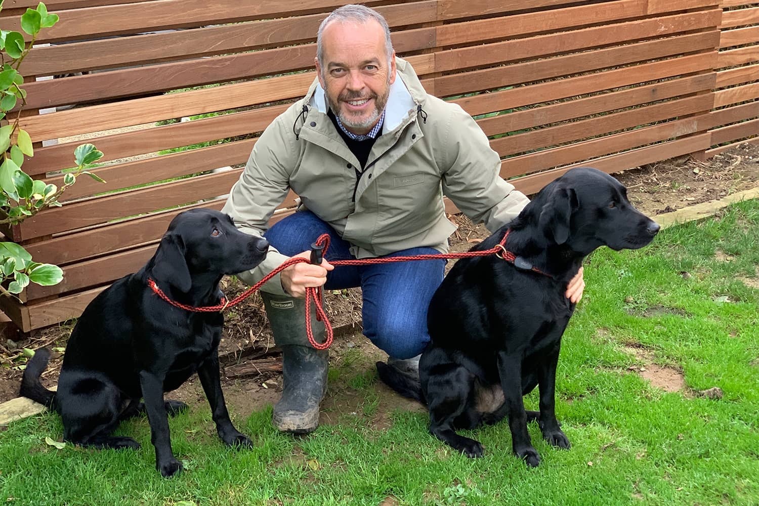 Gripsure Managing Director, Mike Nicholson, with black labradors